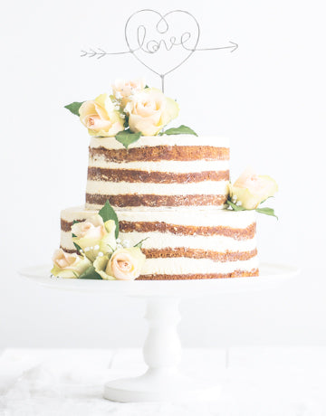 Tiered wedding cake with Love cake topper